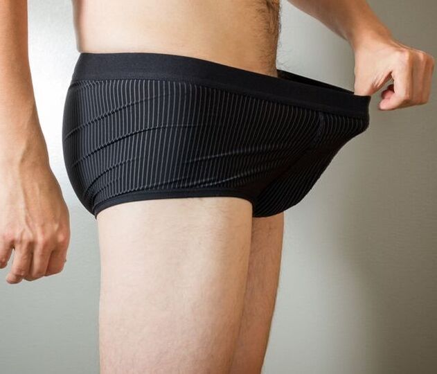 a man looks at his underpants after penis enlargement surgery